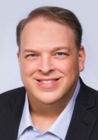 Headshot of Gary Rod with gray background 